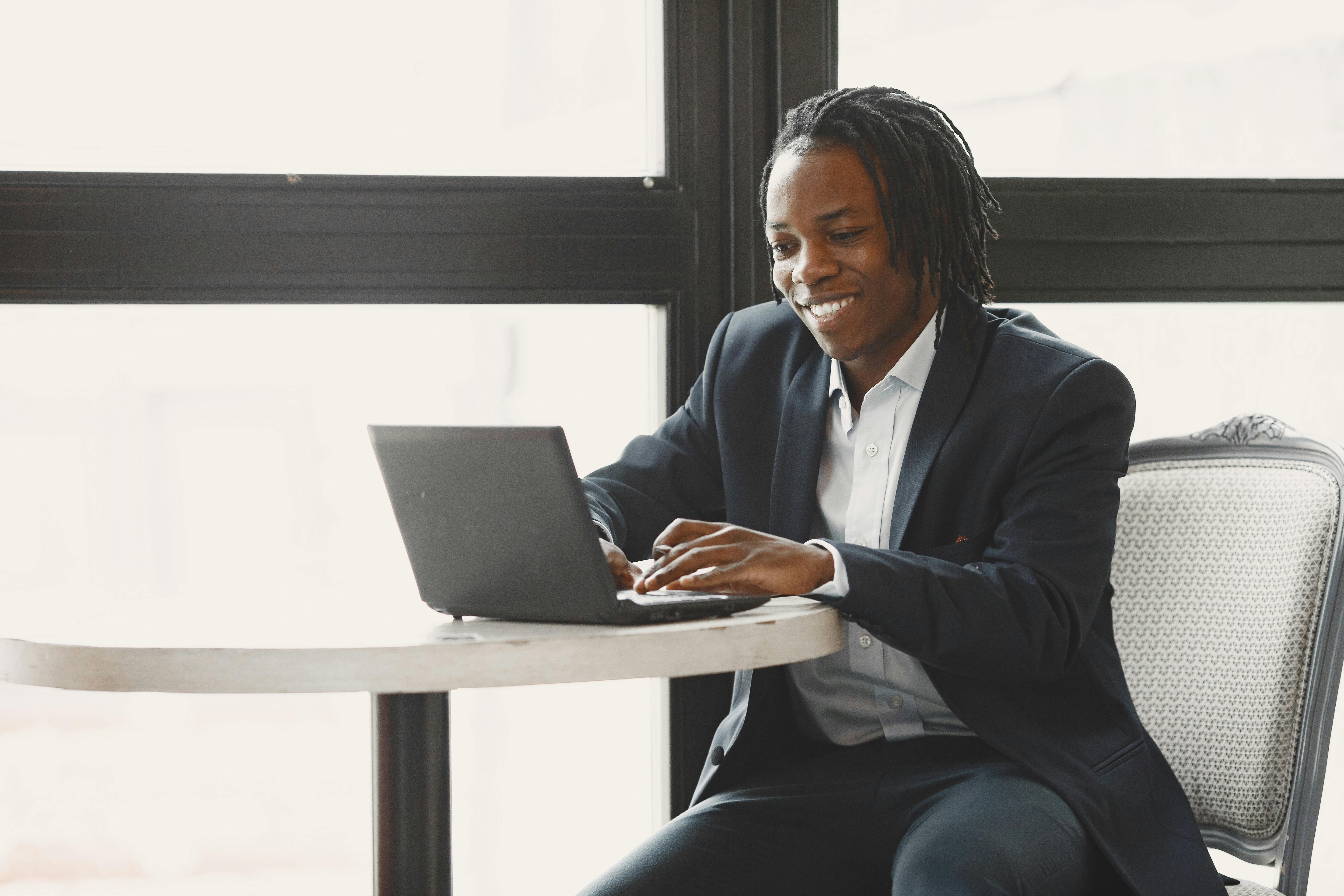 Happy Landlord registering their multifamily property with laptop